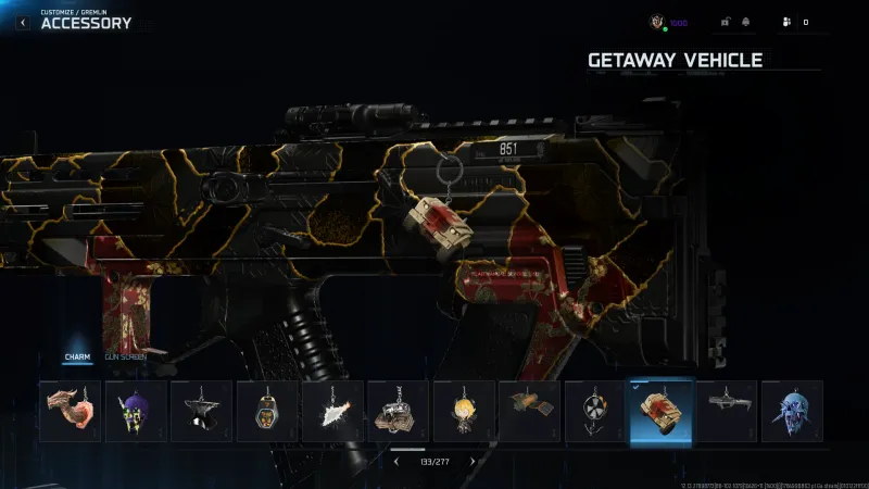 Warzone weapon Accessory screen with the Getaway Vehicle charm selected, showing a small tan JLTV keychain hanging from a gold and red camo SMG in the Gremlin customize menu.