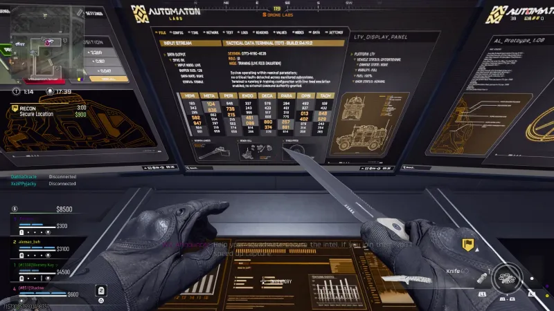 Close view of the Automaton Labs monitor wall upstairs in Drone Labs, showing the Tactical Data Terminal number grid with yellow highlighted digits and an LTV Display Panel listing vehicle status operational and fuel 100 percent.