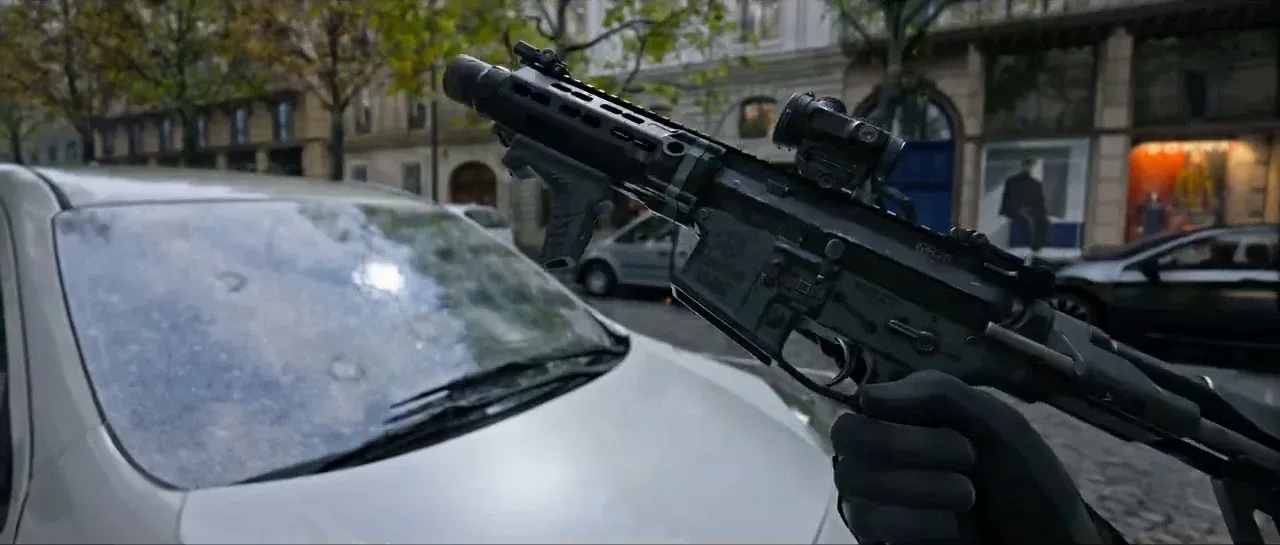 First-person weapon view from the MW4 reveal trailer showing detailed gun model on a Paris street