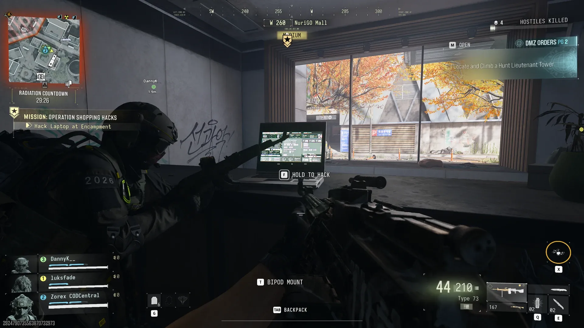 Operation Shopping Hacks Hold to Hack prompt on the encampment laptop at NuriGO Mall while a squadmate stands guard